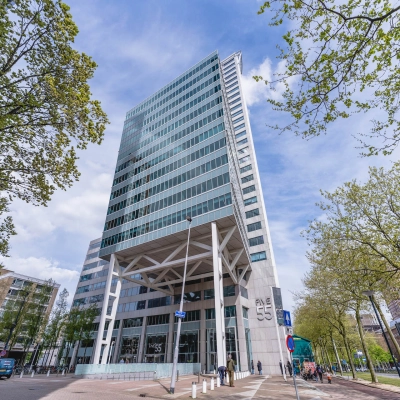 A modern high-rise office building located at Blaak 555 in Rotterdam Center, ideal for those seeking office space rental in the city.