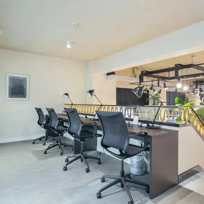 Modern, well-lit office space at Coolsingel 104 in Rotterdam Center, featuring a stylish desk area with chairs and lamps, perfect for rent office space opportunities.