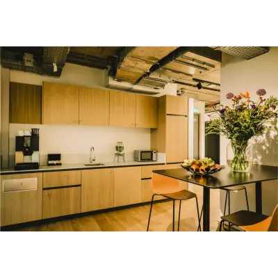 Modern furnished pantry at Coolsingel 65, Rotterdam Center, featuring sleek cabinets and a coffee machine, available for office space rental.