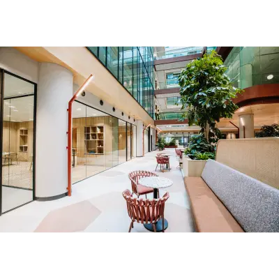 Bright office space to rent in Rotterdam Center, featuring modern interior with seating and glass walls, perfect for collaborative work environments.