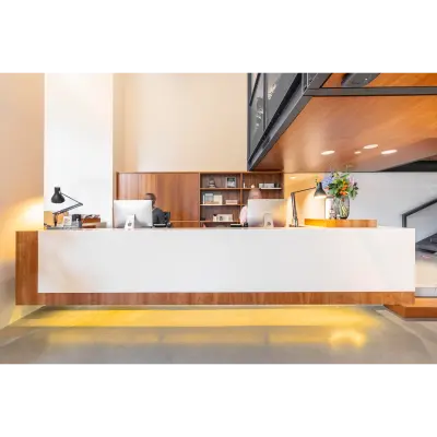 Reception area with a wooden desk and computers at an office in Hofplein 20, Rotterdam Central Station. Ideal for office space rental.