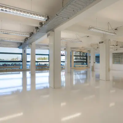 Interior view of a spacious, light-filled office at Lloydstraat 21 B, Rotterdam Delfshaven, available for office space rental. Large windows provide ample natural light.