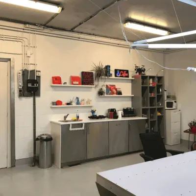 Furnished office space at Van Helmontstraat 17-23, Rotterdam Delfshaven, featuring a kitchenette with shelves, a microwave, and a coffee maker, ideal for your next office space rental.