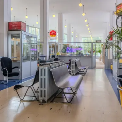 Spacious and bright office space rental in Rotterdam Delfshaven with modern furnishings, including chairs and tables. Ideal for dynamic work activities.