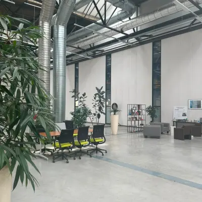 Spacious and modern office space at Scheepsbouwweg 29, featuring high ceilings, ample seating, and greenery, perfect for office space rental in Rotterdam Waalhaven.