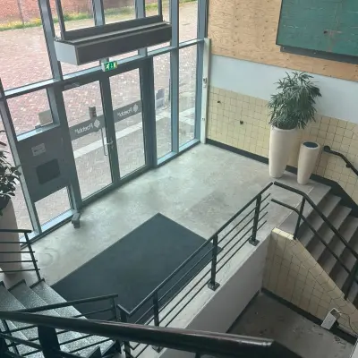 Empty office entrance area at Scheepsbouwweg 29, Rotterdam Waalhaven, featuring modern design elements suitable for office space rental.