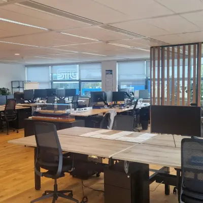 Spacious office space in Rotterdam Waalhaven featuring multiple desks, computers, and plants, ideal for businesses seeking office space rental.