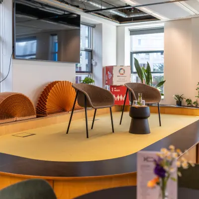 Furnished office space at Fluwelen Burgwal 58, The Hague Center with stylish chairs, small table, and decorative elements. Ideal for office space rental and creative meetings.