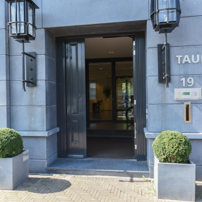 Entrance to office space rental at Koninginnegracht 19, The Hague Center featuring modern exterior with planters.