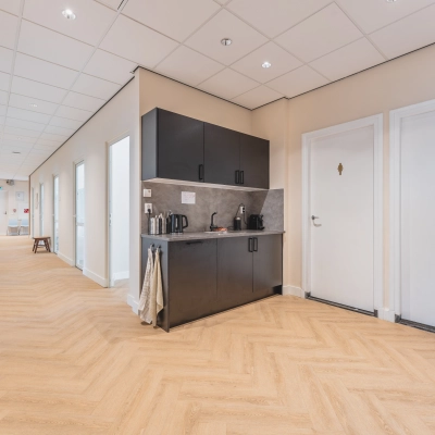 Bright office space with a kitchenette in Zeestraat 100, The Hague Center, available for rent. The corridor leads to various rooms, ideal for any office space rental needs.