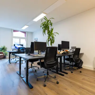 Bright office space at Oudegracht 161, Utrecht Center, featuring desks with computers and chairs, ideal for office space rental needs.