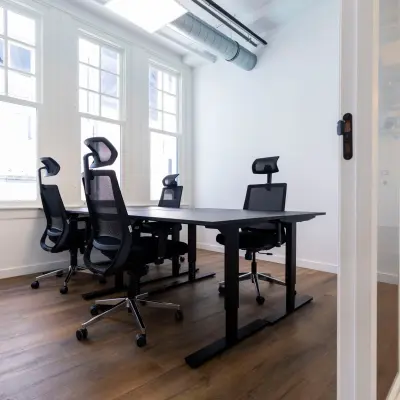 Bright office space rental at Oudegracht 161, Utrecht Center, featuring modern desks and chairs with natural light streaming in.