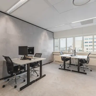 Furnished office space at Leidseveer 2-10, Utrecht Central Station, featuring desks and chairs with computers for office space rental.