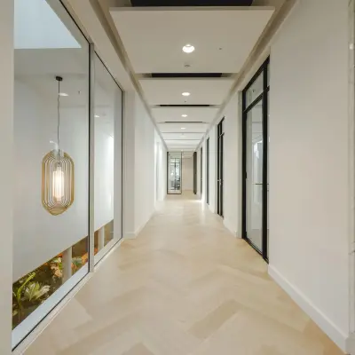 Bright hallway at Moreelsepark 1, Utrecht Central Station, ideal for office space rental with sleek design and modern lighting.