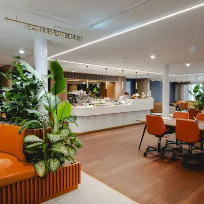 Modern office space rental at Moreelsepark 1, Utrecht Central Station, featuring stylish furnishings and vibrant greenery for a dynamic work environment.