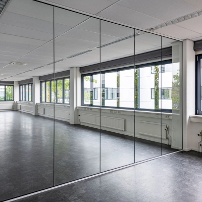 Spacious interior office space with large windows and reflective partitions, offering ample natural light at Atoomweg 350, Utrecht Lage Weide. Ideal for office space rental.