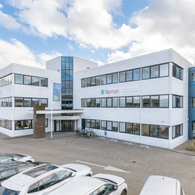 Exterior view of office building at Atoomweg 400 in Utrecht Lage Weide, showcasing a modern facade with ample parking space, ideal for those seeking office space rental.
