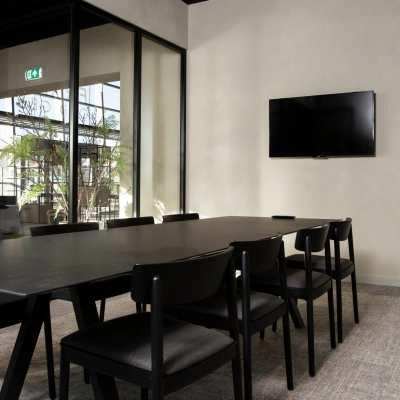 Conference room available for office space rental at Atoomweg 63, Utrecht Lage Weide, featuring a sleek meeting table, chairs, and a wall-mounted TV.