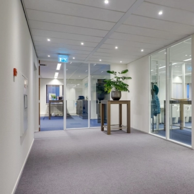 Modern office space at Atoomweg 63, Utrecht Lage Weide, featuring a clean, furnished interior with glass partitions and plants. Ideal for office space rental.