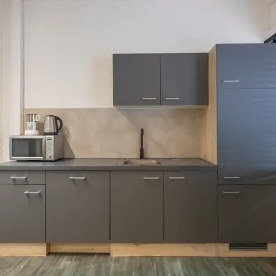 Compact kitchenette in an office space at Zonnebaan 18, Utrecht Lage Weide, featuring modern cabinets and essential appliances for convenient office space rental.
