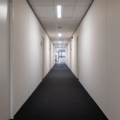 Long hallway with doors on each side, leading to office spaces for rent at Zonnebaan 18 in Utrecht Lage Weide.