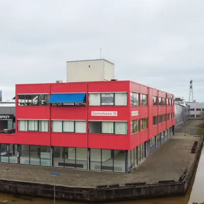 Exterior view of the office building at Zonnebaan 18, Utrecht Lage Weide, showcasing its unique design and commercial surroundings. Ideal for office space rental with easy accessibility.