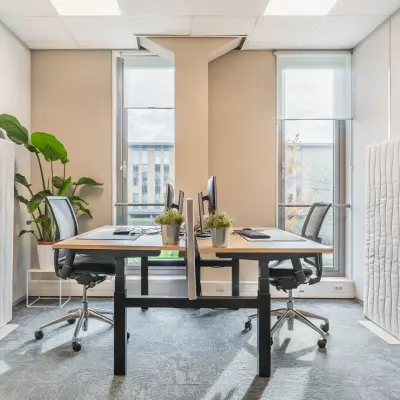 Modern office space rental in Utrecht Papendorp with large windows, two desks, and ergonomic chairs, enhancing a bright and inviting atmosphere for productivity.