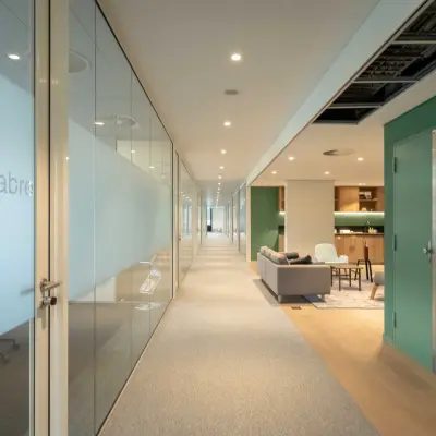 Bright interior hallway at Van Deventerlaan 31-51, Utrecht Papendorp, showcasing modern office space rental with glass partitions and chic lounge area for rent office space.