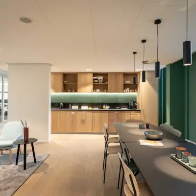 Modern office space for rent at Van Deventerlaan 31-51, Utrecht Papendorp, featuring a stylish interior with sleek furnishings, a long table, and a cozy seating area.