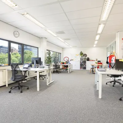 Bright, furnished office space at Winthontlaan 200, featuring modern workstations overlooking Utrecht South, available for office space rental.