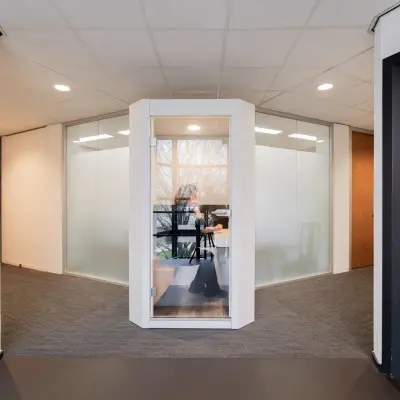 Modern office space for rent at Winthontlaan 200, Utrecht South, featuring a glass-walled workspace with a person working at a desk.