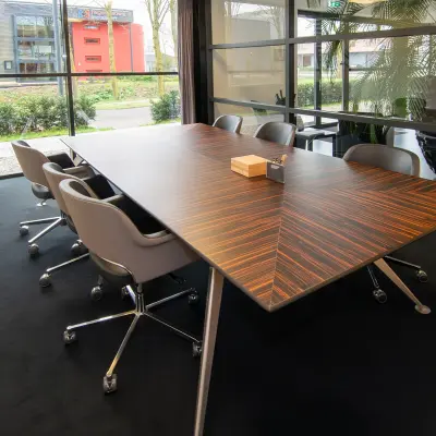 Spacious conference room at Gildestraat 13, Velp with a sleek wooden table and comfortable chairs, ideal for office space rental.