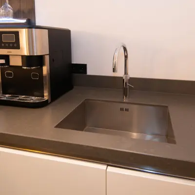 Kitchen area with a sleek counter and modern coffee machine at office space rental in Velp.