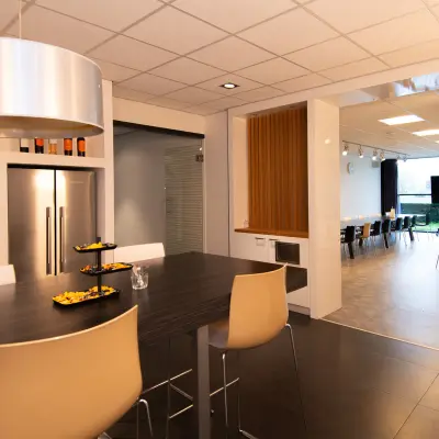 Modern furnished office space at Gildestraat 13, Velp with sleek kitchen area and spacious meeting room, available for rent.