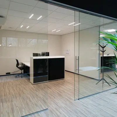 Modern office space featuring sleek wooden flooring and glass partitions at Gildestraat 13, Velp. Perfect for your next office space rental.