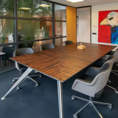 Office to rent at Gildestraat 13, Velp featuring a modern conference room with a large table and swivel chairs, showcasing vibrant artwork.