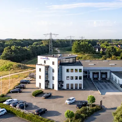 Exterior view of office space for rent at Keizersveld 47, Venray, with ample parking and nearby road access.