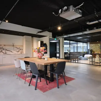 Modern office space at Havenweg 24, Vianen Utr featuring a communal table, stylish seating, and vibrant decor. Ideal for office space rental.
