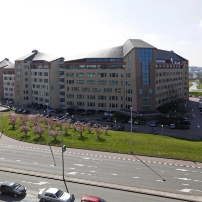 Exterior view of a modern office building at Loire 104-206 in Voorburg, featuring ample parking and easy access for potential office space rental.