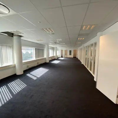 Spacious office to rent at Regulusweg 11, Voorburg, featuring large windows and a modern, open floorplan perfect for office space rental needs.