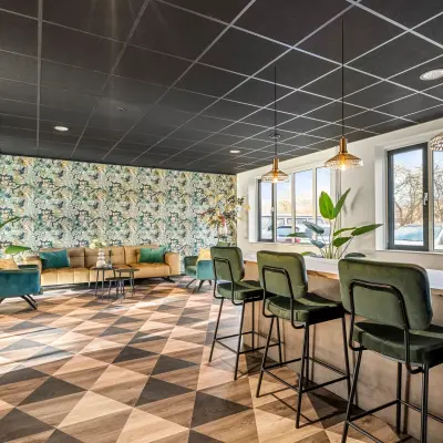 Stylish office space available for rent at Agro Business Park 22, Wageningen, featuring a modern and inviting lounge with comfortable seating and a vibrant design.