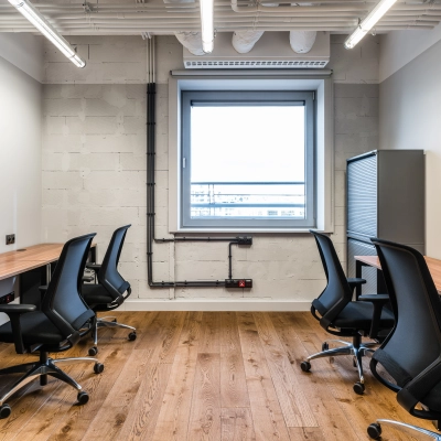 Furnished office space for rent at Konstruktorska 11, Warsaw Mokotow, featuring multiple workstations and modern lighting.