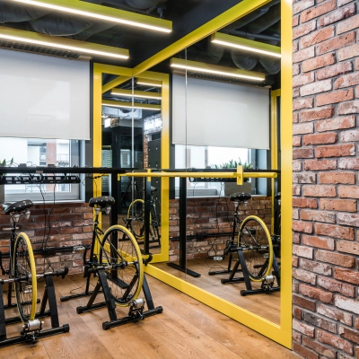 Interior space at Konstruktorska 11, Warsaw Mokotow featuring stationary bicycles, ideal for informal meetings. Consider this office space rental for a dynamic work environment.