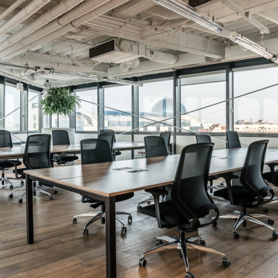 Spacious office to rent at Al. Jerozolimskie 181B, Warsaw Ochota, featuring modern workspaces with sleek desks and chairs, ample natural light, and a view of the city skyline.
