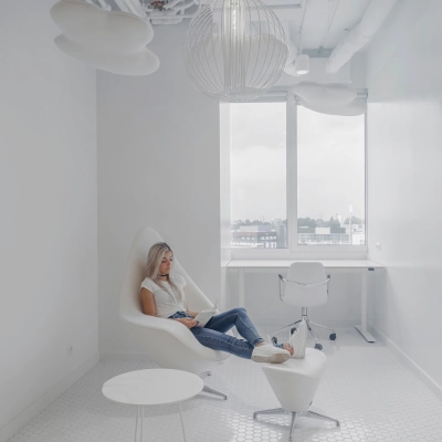 Bright office to rent at Al. Jerozolimskie 181B, Warsaw Ochota, featuring a modern, minimalist workspace with a woman working on a laptop.