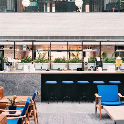 Modern office lounge with a central bar at Grzybowska 60, Warsaw Wola, ideal for office space rental.