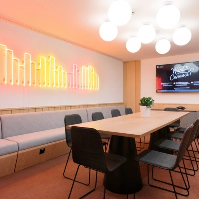 Modern office space at Grzybowska 60, Warsaw Wola with stylish lighting, long table, and chairs ideal for office space rental.