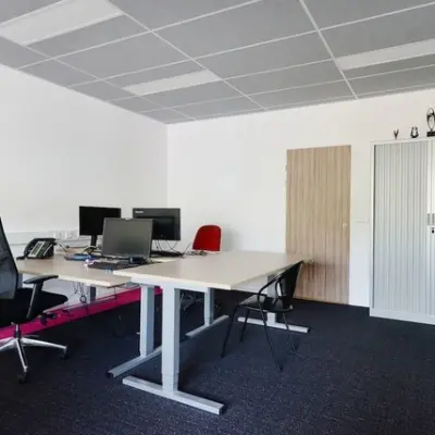 A furnished office space available to rent at Molenweer 2, Wateringen, featuring desks, chairs, and computer monitors in a bright, tidy environment.