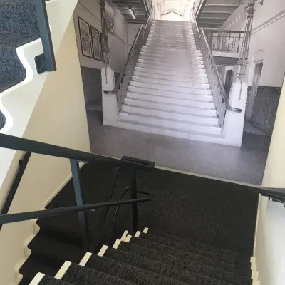 Staircase with patterned wall showcasing an artistic stair photo at the office located at Houttuinlaan 4, Woerden.