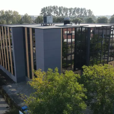Modern office building at Pompmolenlaan 9 in Woerden, ideal for those seeking office space rental with ample parking.